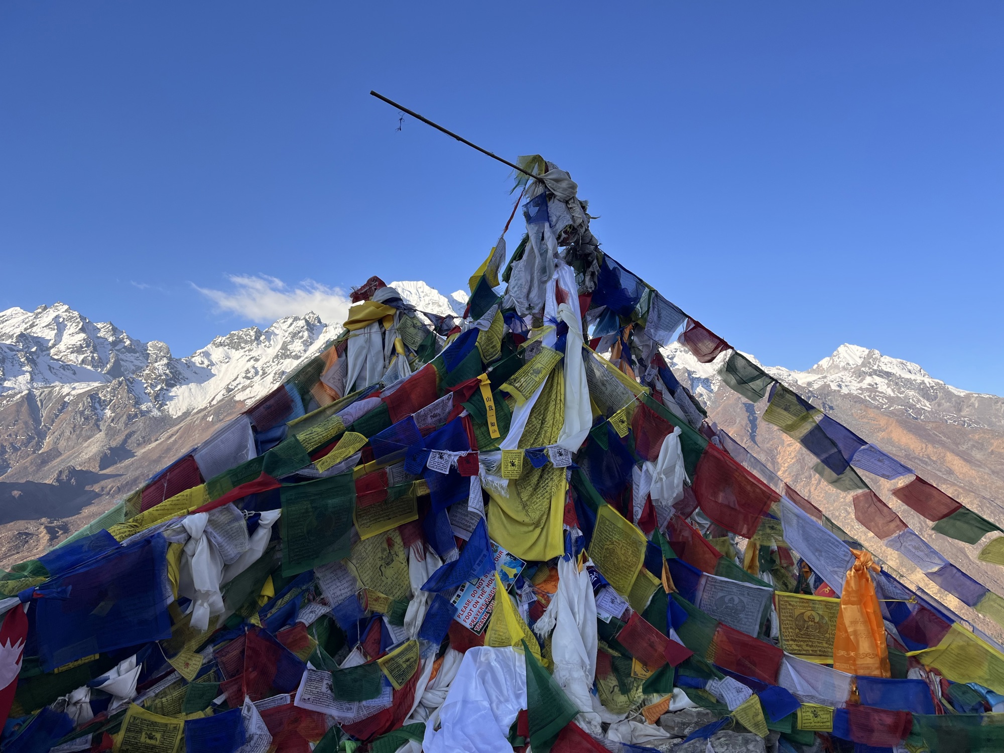 Prayer flags collected at the top of a hill